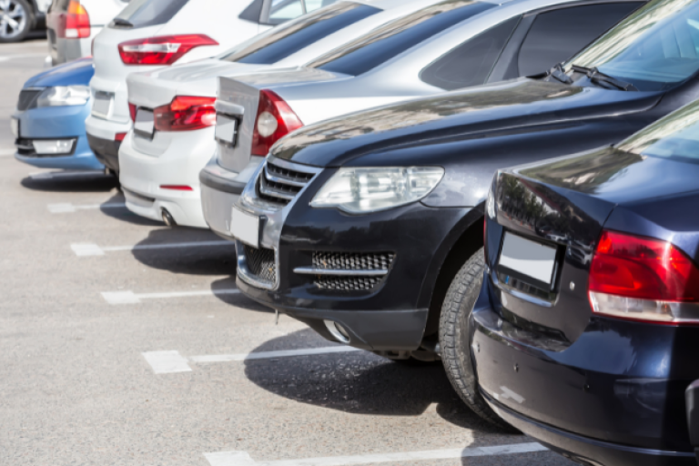 Cars parked in parking spaces of a car park